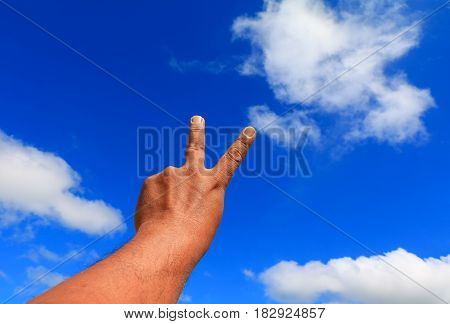 hand two fingers. concept on sky background