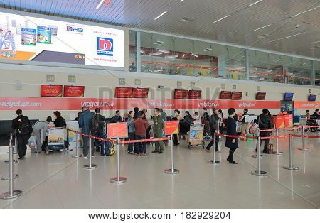 HANOI VIETNAM - NOVEMBER 25, 2016: Unidentified people check in at Vietjet Air counter Hanoi International airport.