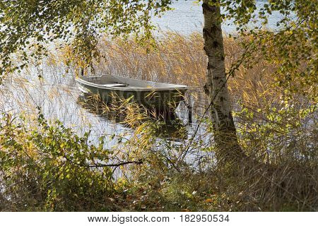 Dinghy moored to a post in a lake near Silkeborg Denmark