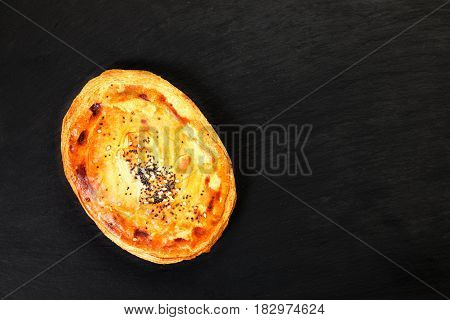Freshly salmon pie on black slate plate