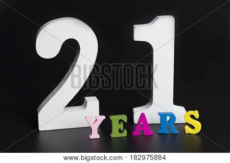 Letters and numbers twenty-one years on black isolated background.