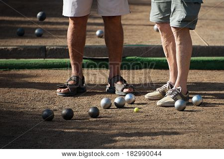 Old mens playing petanque in a city park,relaxation game