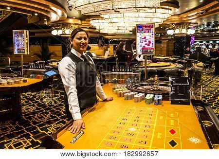 Cruise liner Splendida - April 23, 2017: Croupier in gaming casino interior of Cruise liner Splendida, MSC