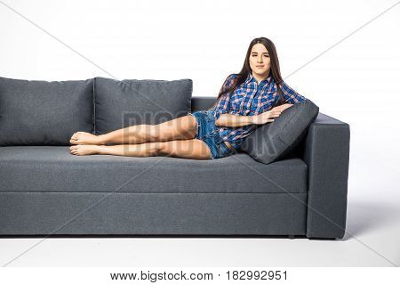Woman Resting On A Sofa While Looking At The Camera On White Background