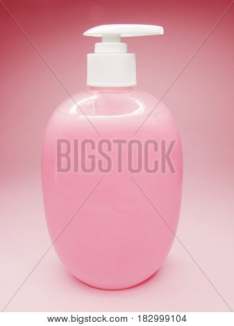 liquid soap with rose extract on colored background