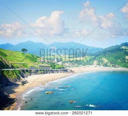 Cantabrian Sea Green Coast With Deba Town Under Summer Sky, Pais Vasco Spain, Toned