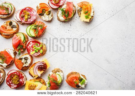 Assorted Spanish Tapas With Fish, Sausage, Cheese And Vegetables. White Background, Frame Food, Copy
