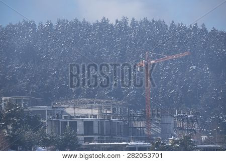 27 Jan, 2019, Shiroka Poliana Dam, Bulgaria. Building And Orange Crane In A Forest In The Mountain. 