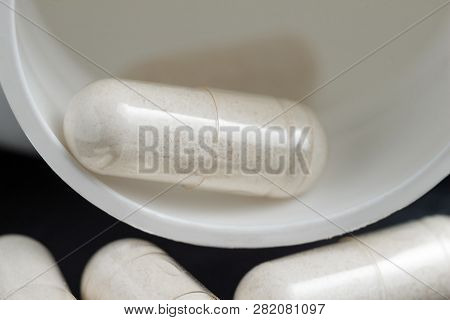 White Medical Capsules Of Glucosamine Chondroitin, Healthy Supplement Pills, Macro Image.