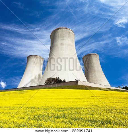 Nuclear Power Plant Dukovany, Cooling Tower With Golden Flowering Field Of Rapeseed, Canola Or Colza