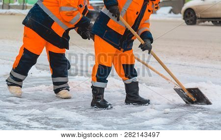 Communal Services Workers Sweep Snow From Road In Winter, Cleaning City Streets And Roads After Snow
