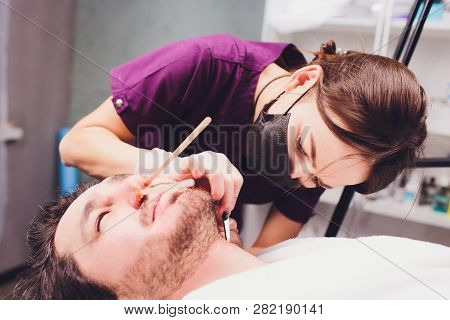 Hair Removal. Mans Face Sugaring Epilationsy Ellow Color, In Cosmetology On The Couch. Hair Removal 