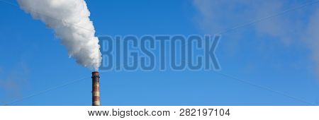 White Smoke Comes From Pipes Against Blue Sky. Problem Harmful Emissions And Air Pollution Of Centra