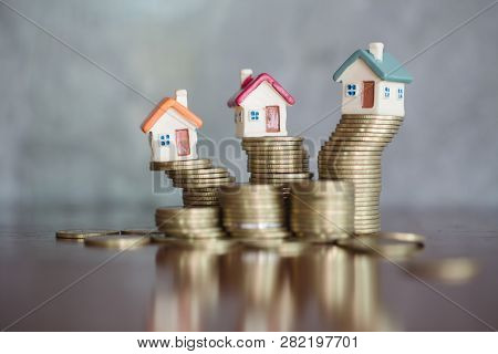 Mini House On Stack Of Coins,money And House,  Mortgage, Savings Money For Buy House And Loan To Bus