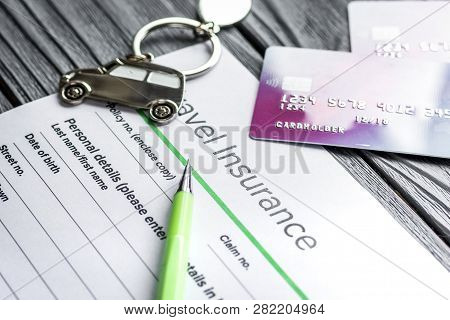 Travel Preparation Concept With Insurance And Cards On Wooden Table