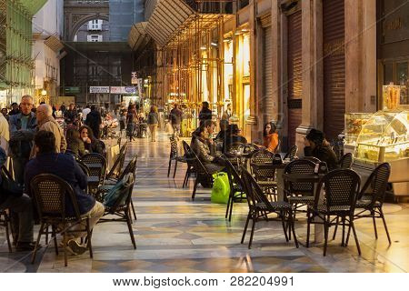 Naples, Italy - October 31, 2015: Unknown People Resting In The Galleria Umberto I At Evening. Galle