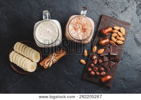 Banana And Chocolate Smoothie In Two Jars, Protein Milkshake, Nuts, Chocolate Cubes, Banana Slices, 