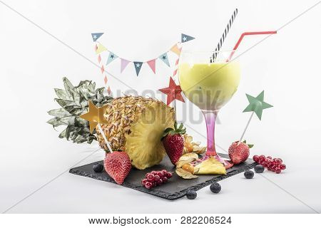 Pineapple Smoothie In A Balloon Glass With Fruits On A White Background