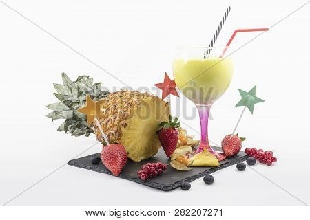 Pineapple Smoothie In A Balloon Glass With Fruits On A White Background