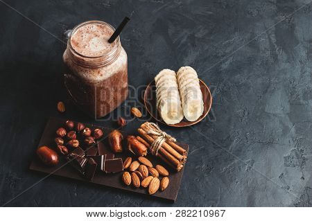 Chocolate Smoothie In A Jar, Protein Milkshake, Nuts, Chocolate Cubes, Banana Slices, Dates, Cinnamo