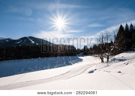 Cross-country Skiing Track Trail In Snow-covered Holiday Resort Hohentauern With Nice Sunbeams In Wi