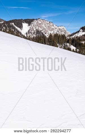 Snow Covered Slope In Holiday-resort Hohentauern With Mountain Sunkmauer On A Sunny Day In Winter In