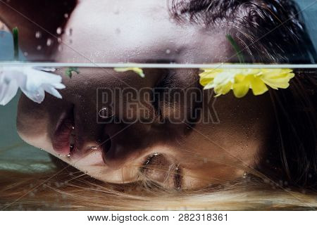 Close Up Of Beautiful Girl Posing Over Water With Flowers