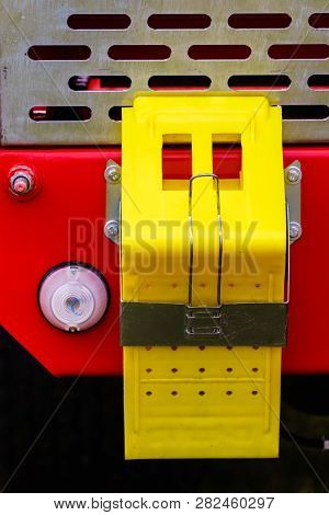 Close Up On Yellow Pin Stopping Wedge, Tractor Machine Vehicle Details Concept.