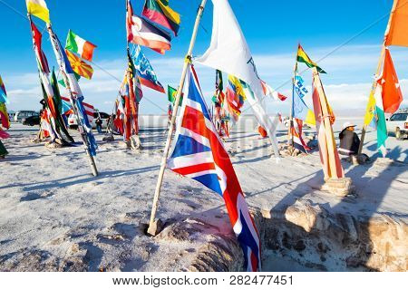 Salar de Uyuni, Bolivia - 21 October 2018: Sunshine bright flags from different countries