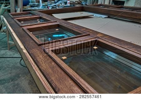 Wood Door Manufacturing Process. Glazed Door Frame, Painted In Dark Color. Furniture Manufacture.