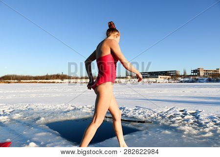 Young Woman Crosses Herself Plunging Into Icy Water During Ukraine