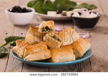 Spinach Puffs With Feta Cheese On Cutting Board.