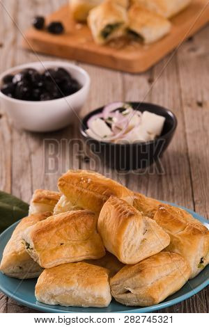 Spinach Puffs With Feta Cheese On Cutting Board.