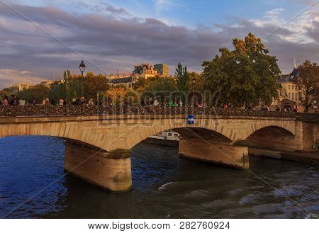 View Onto The Seine And The Pont De L'archeveche Or Archbishop's Bridge , Famous For Love Locks Near
