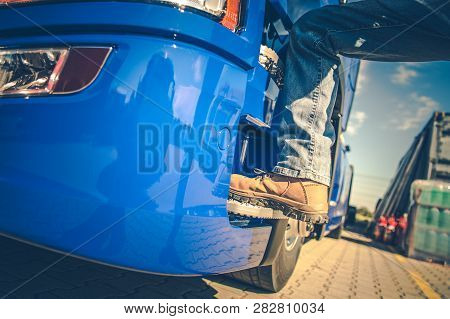 Commercial Driver Getting Into The Semi Truck. Closeup Photo. Transport Industry.
