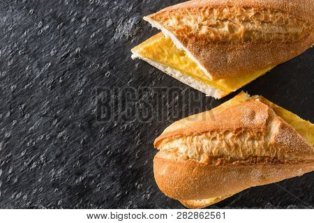 Bocadillo De Tortilla Española. Spanish Potato Omelette Sandwich On Slate Background. Top View. Copy