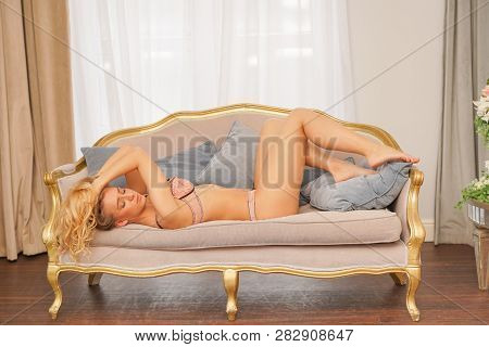 beautiful caucasian blonde girl in pink lace lingerie