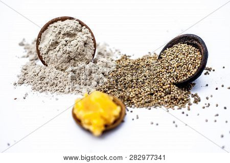 Close Up Of Grain Of Pearl Millet Or Bajra Or Bajri In A Clay Bowl With Its Flour And Jaggery In A S
