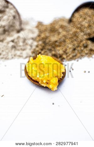 Close Up Of Grain Of Pearl Millet Or Bajra Or Bajri In A Clay Bowl With Its Flour And Jaggery In A S