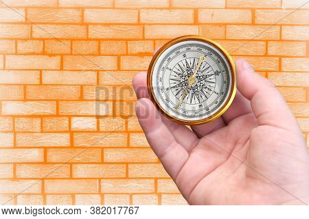 Abstract Photo With Compass In Hand On Brick Wall Background As Symbol Of Tourism With Compass, Trav