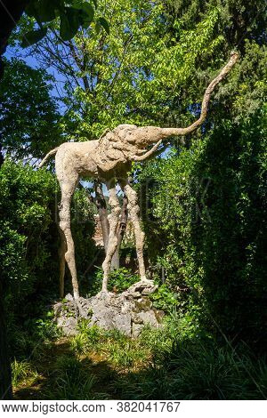 Pubol, Spain - May 23, 2014: Elephant With Long Legs And A Long Trunk Sculpture On A Sunny Day In Th