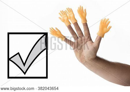Hand On A White Background On Her Fingers Is Wearing A Toy In The Shape Of A Hand. Concept. No Choic