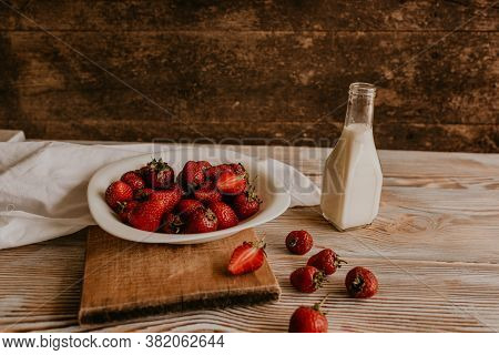 Juicy Red Strawberry Lies On The Wooden Board