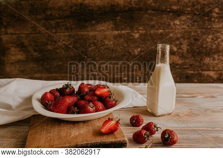 Juicy Red Strawberry Lies On The Wooden Board