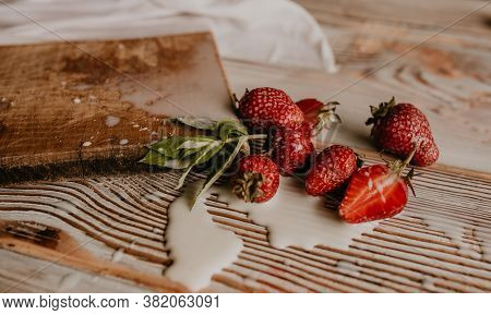 Juicy Red Strawberry Lies On The Wooden Board