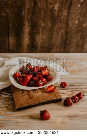Juicy Red Strawberry Lies On The Wooden Board