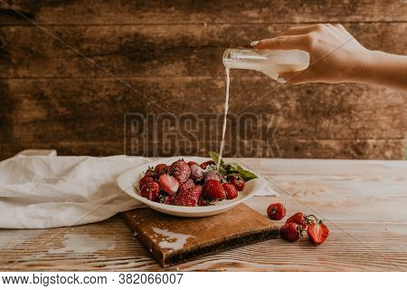 Juicy Red Strawberry Lies On The Wooden Board