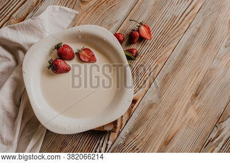 Juicy Red Strawberry Lies On The Wooden Board