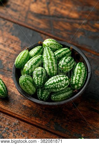 Freshly Picked Cucamelon In Rustic Bowl On Wooden Table