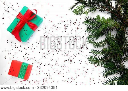 Two Christmas Gifts On The White Background And Christmas Tree